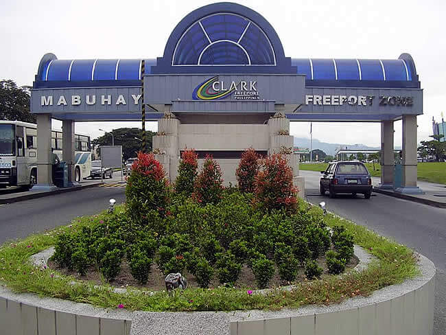 Facade of the Bureau of Immigration building, featuring large windows.