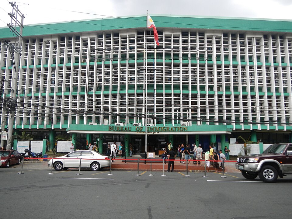 BI_optimized_2 Facade of the Bureau of Immigration building, featuring large windows.